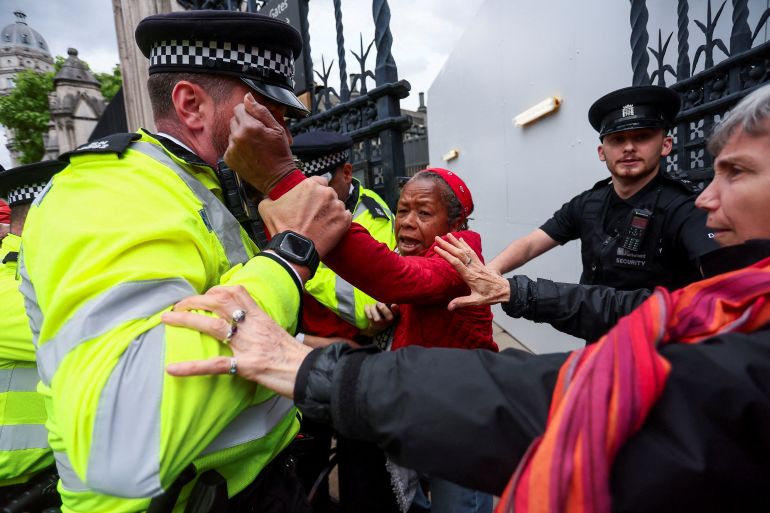 A police officer holds a Pro-Palestinian protester on the day of a demonstration outside the Parliament, organised by campaign groups including Palestine Solidarity Campaign, Avaaz and Parents for Palestine, calling for sanctions on Israel over ongoing hunger among Gaza's war-struck population, in London, Britain, June 4, 2025. REUTERS/Isabel Infantes TPX IMAGES OF THE DAY