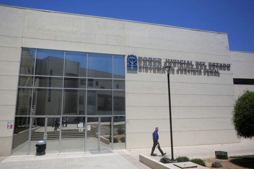Prosecutor Raul Gerardo Cobo Montejano leaves the Baja California State Palace of Justice, where four individuals appeared in court on charges related to the murder of Australian brothers Jake and Callum Robinson and their friend Carter Rhoad, in Ensenada, Mexico, on July 25, 2025.