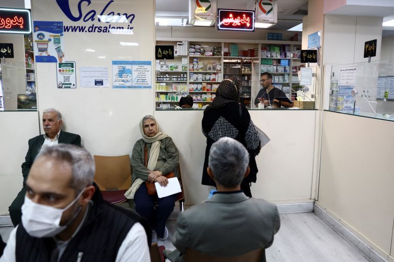 People buy at a pharmacy in Tehran [File: Majid Asgaripour/WANA]