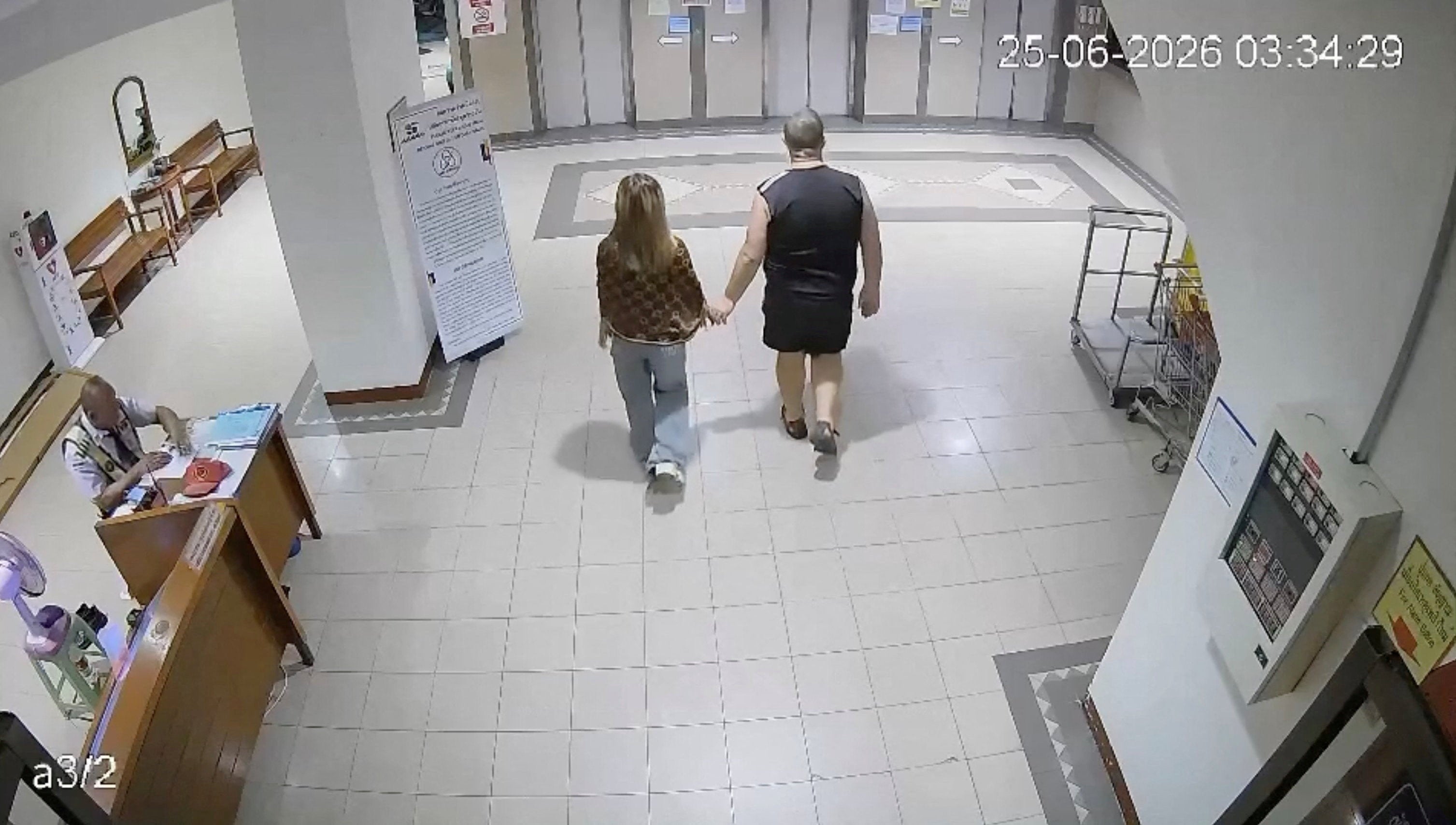 A man identified as Simon Peter Carman walks with a 17-year-old Thai girl, whose body was later found in a suitcase, at a condominium in Pattaya City, Thailand