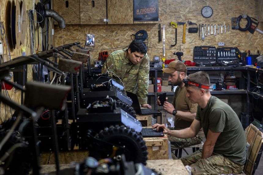 Soldiers from Ukraine’s Third Army Corps prepare new vehicles for field use in a workshop in the Kharkiv region in May 2026. REUTERS/Thomas Peter