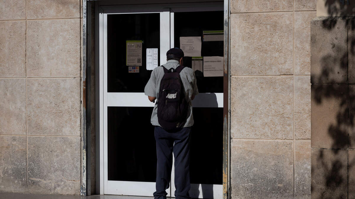 A man peers through the door of a bank in Havana on Sept. 17, 2026.