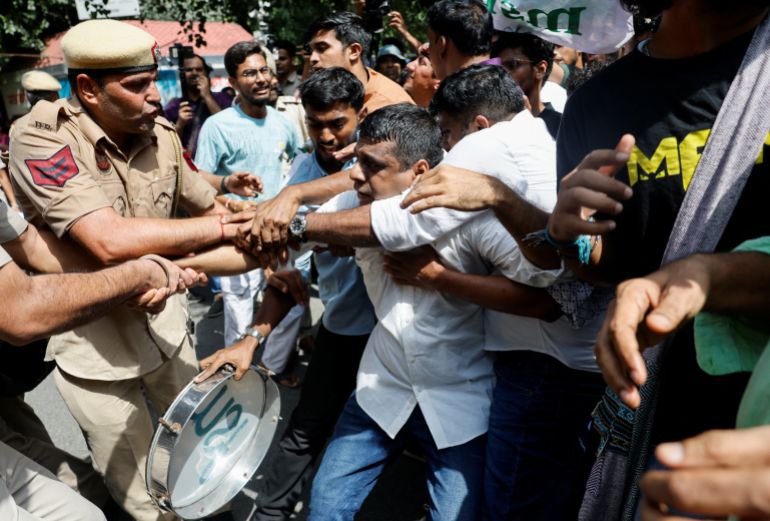 Protesters reacts as they are detained by the police during a protest demanding the resignation of India's Chief Election Commissioner Gyanesh Kumar, in New Delhi, India, October 2, 2026. REUTERS/Adnan Abidi