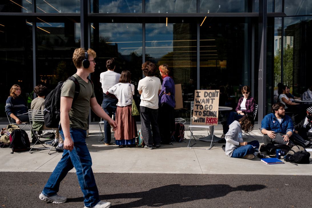 Some of the Cornell University students taking part in a seven-hour sit-in protest representing the seven hours that a Jane Doe alleges she was sexually assaulted in a case involving seven members of Cornell University's Chi Phi fraternity sit outside Toni Morrison Dining Hall, while other participants remain inside, in Ithaca, New York, on October 7.
