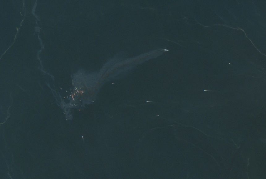 A satellite image shows floating containers and an oil slick in the Strait of Hormuz after the GFS Pride sank.