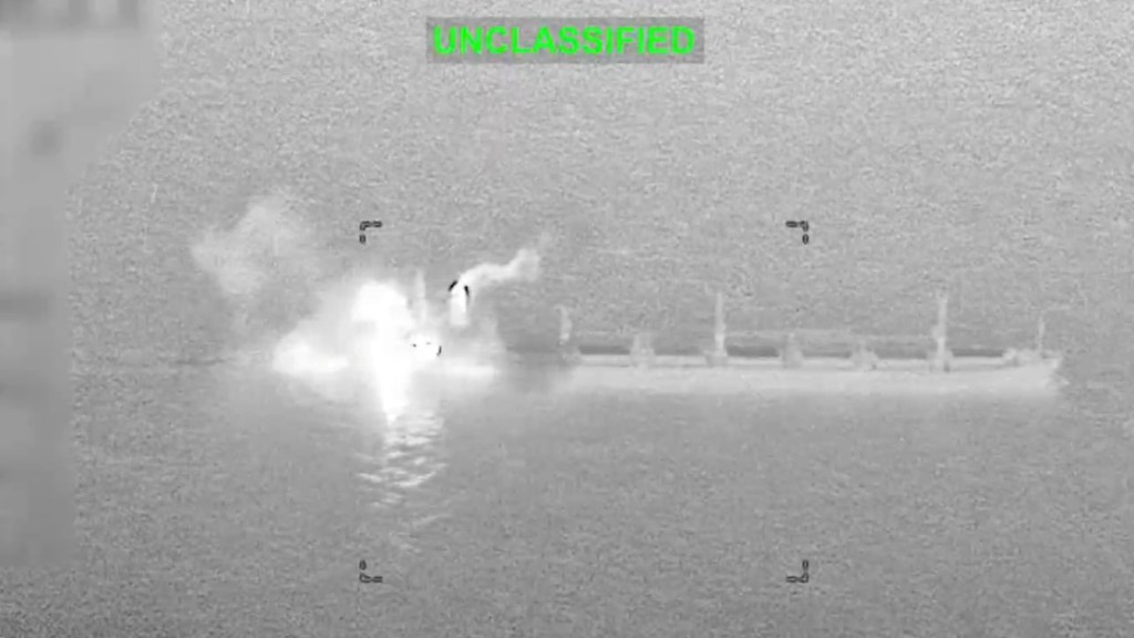 Thermal imaging shows smoke and fire rising from a cargo vessel following a military strike in the Gulf of Oman.