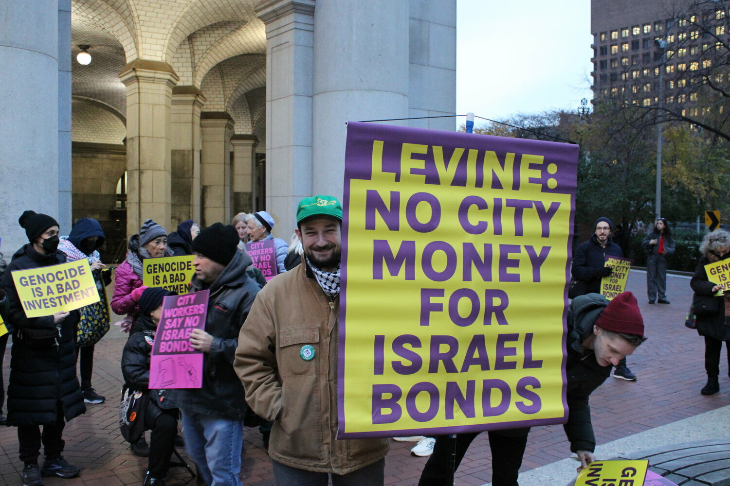 A member of District Council 37 holds a sign imploring incoming Comptroller Mark Levine not to invest the city