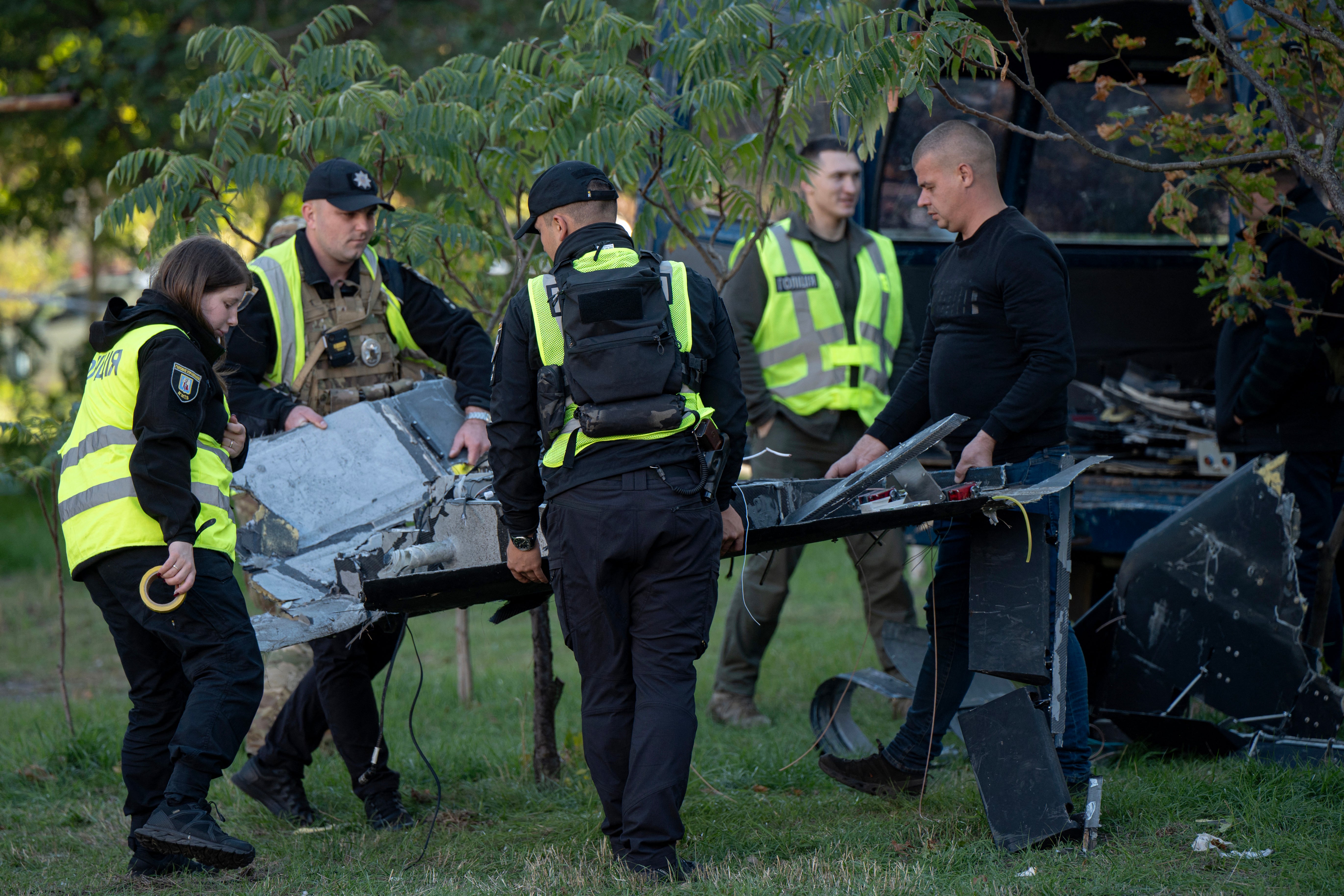Ukrainian police officers collect debris of a Russian drone that crashed near a children's playground among residential buildings and did not detonate, in Kyiv on 30 September 2026, amid the Russian invasion of Ukraine