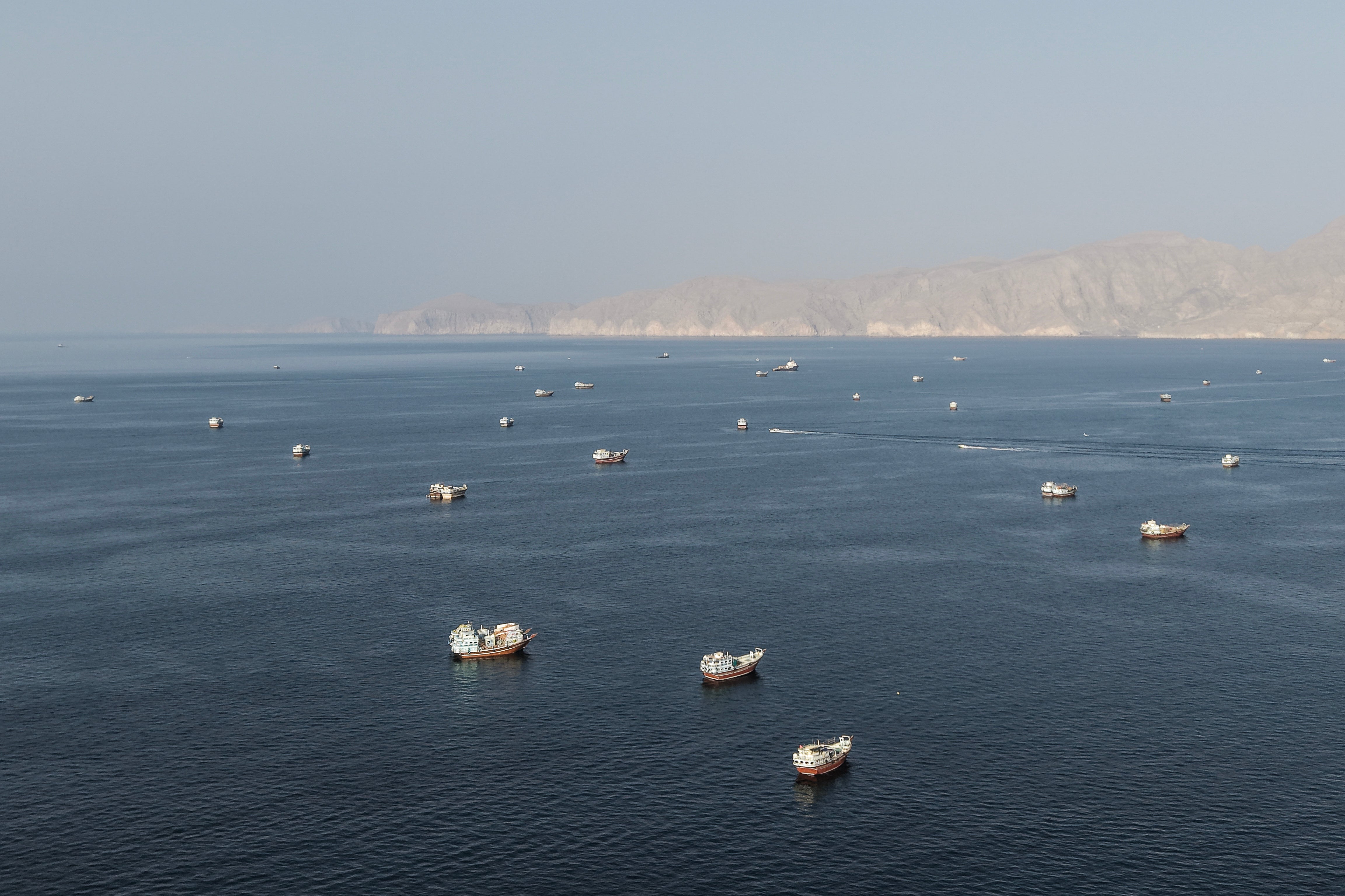 An aerial view shows ships anchored off the coast of Khasab in Oman's Musandam Governorate, near the Strait of Hormuz, on October 2, 2026.