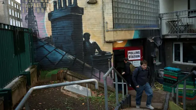 A polling station in Holborn and St Pancras, with a "Polling Station" sign visible beside graffiti