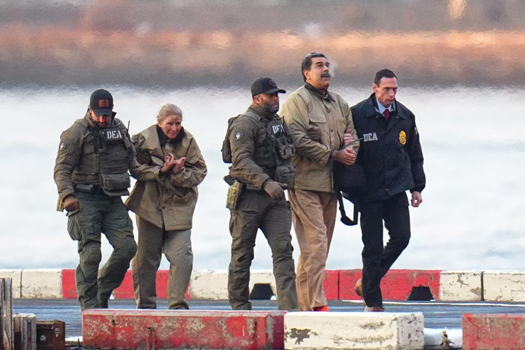 Nicolas Maduro and his wife, Cilia Flores, in handcuffs
