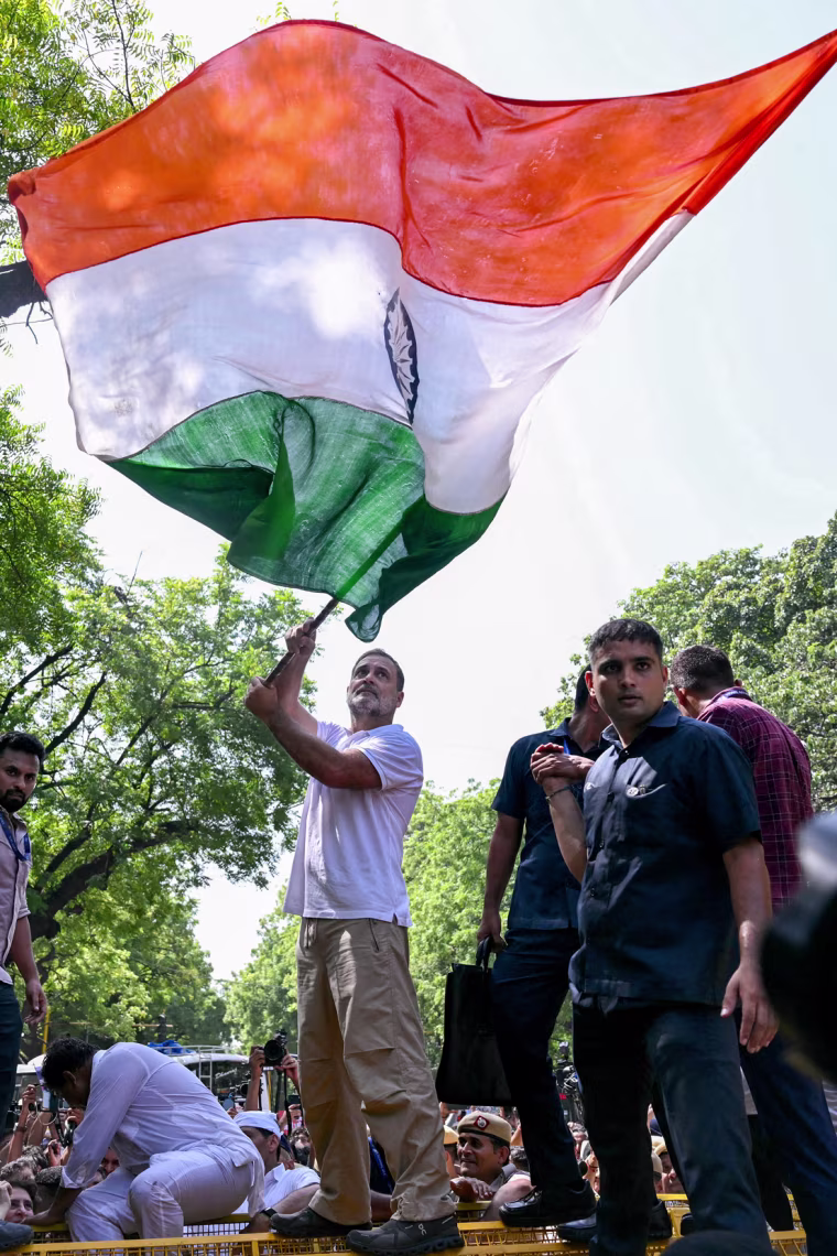 Indian National Congress party leader Rahul Gandhi waves India's national flag.