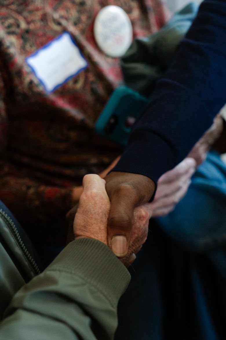 Sen. Raphael Warnock shakes hands with a voter in Nashua, New Hampshire, on October 6.
