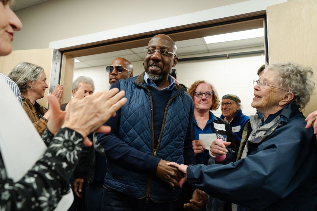 Sen. Raphael Warnock greets a packed room during the opening of a new campaign office for Sen. Chris Pappas in Swanzey, New Hampshire, on October 6.