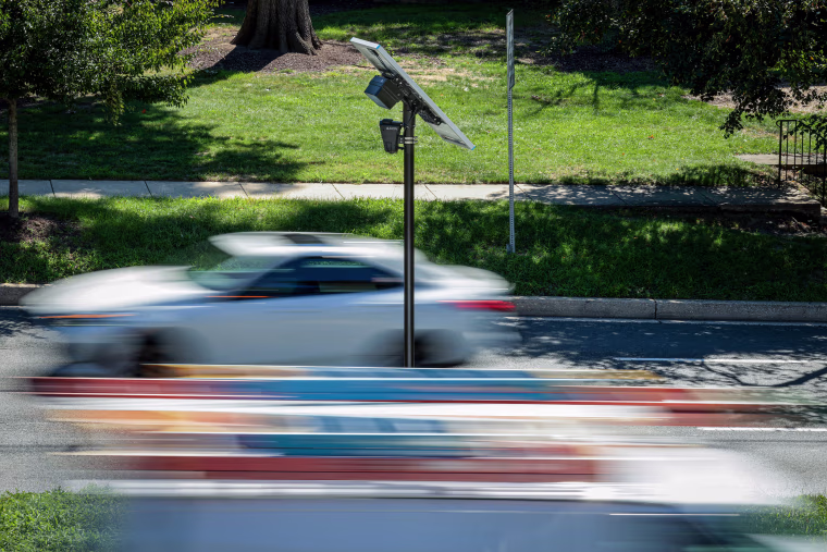 Flock camera as cars pass by.