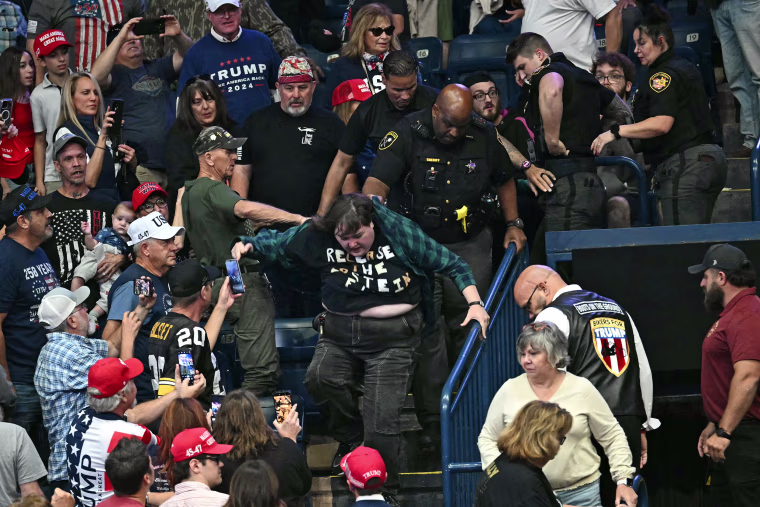 A protester is removed as President Donald Trump speaks in Youngstown, Ohio, on Oct. 12, 2026. 