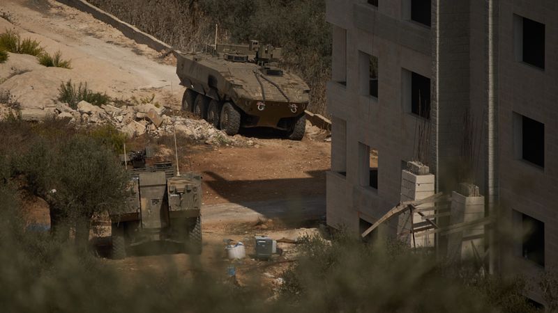 Israeli armored vehicles are seen parked outside a Palestinian building in the West Bank town of Turmus Ayya, Friday, Oct. 23, 2026. (AP Photo/Leo Correa)