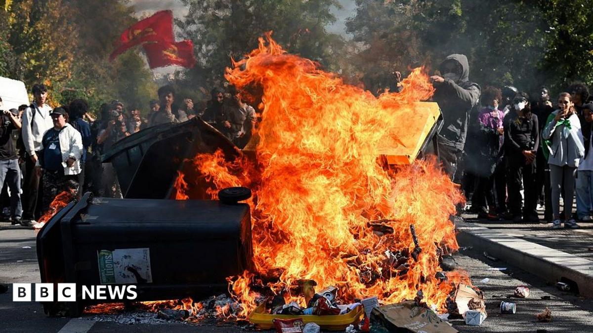 A young man pushes a trash in a fire during an overflow during the blockade of the Lycee Le Corbusier A Aubervilliers, Ile-de-France, France, October 1, 2026