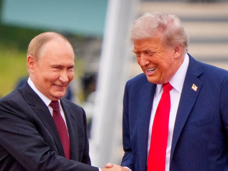 U.S. President Donald Trump (R) greets Russian President Vladimir Putin as he arrives at Joint Base Elmendorf-Richardson on August 15, 2025 in Anchorage, Alaska.