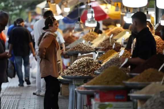 A woman shops at a market selling nuts, dried fruits and spices in Iran. (undated)