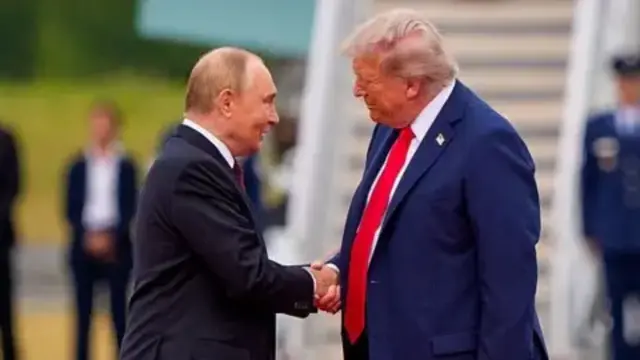 Russian President Vladimir Putin shaking hands with US President Donald Trump