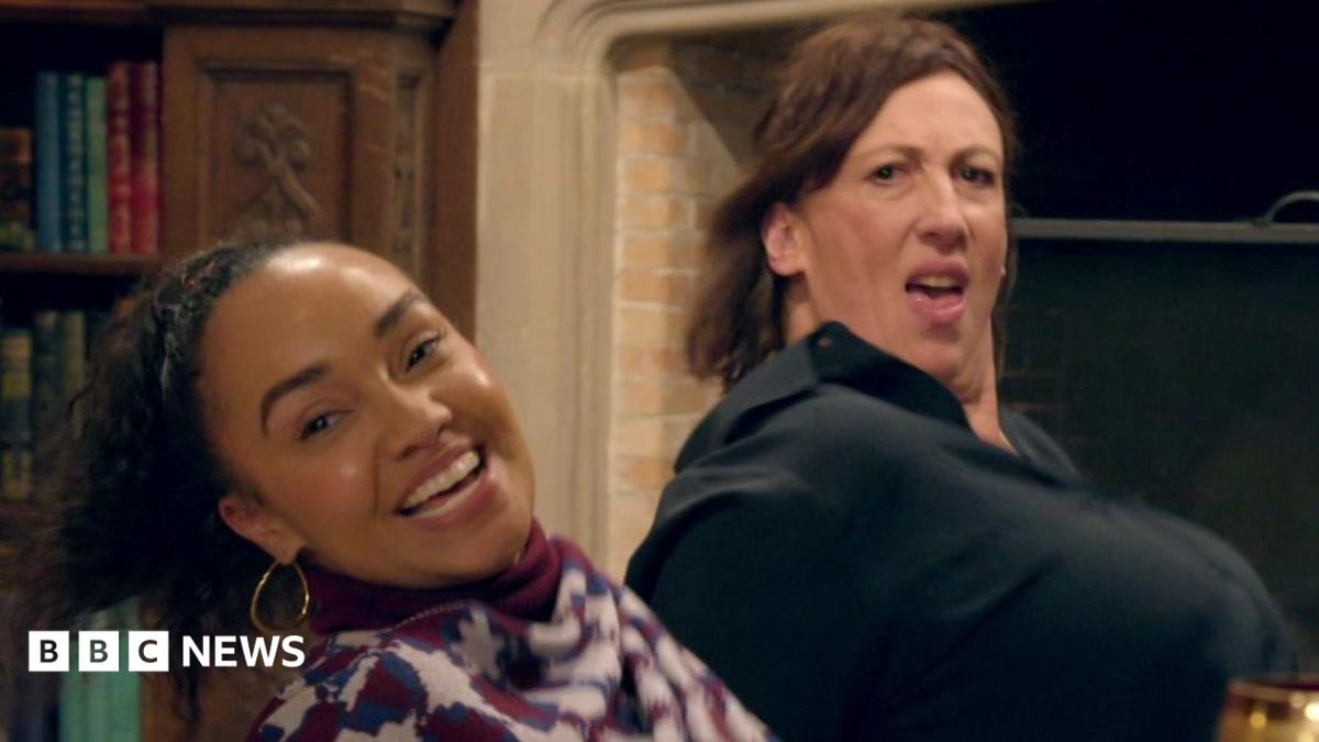 Leigh-Anne and Miranda sitting on the floor and leaning backwards in the middle of a dance move