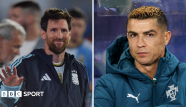 Lionel Messi waves, Cristiano Ronaldo sat in dug out