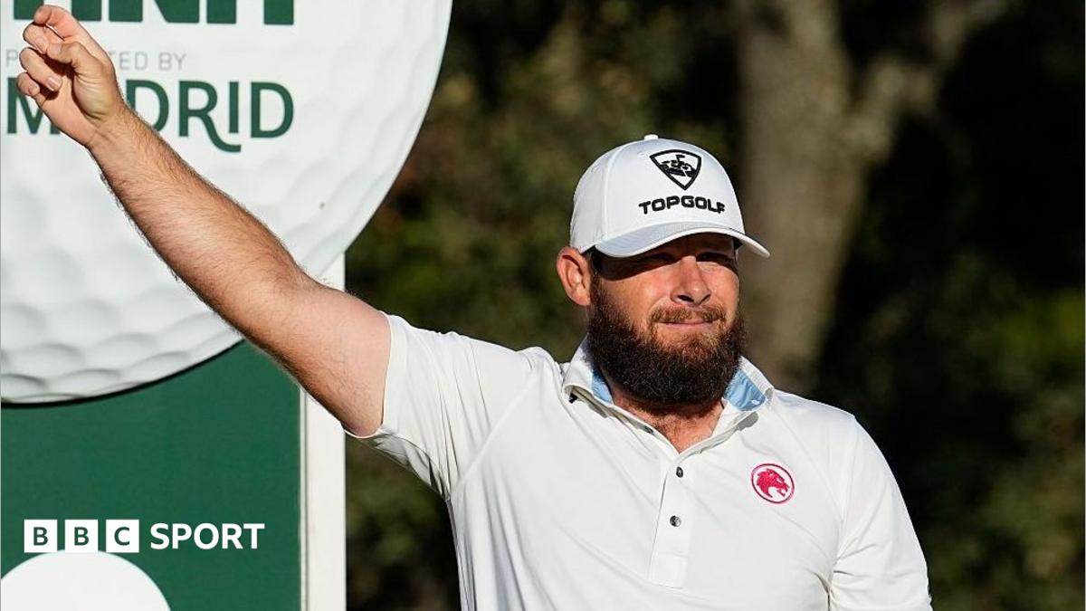 Tyrrell Hatton holds his arm out on the golf course