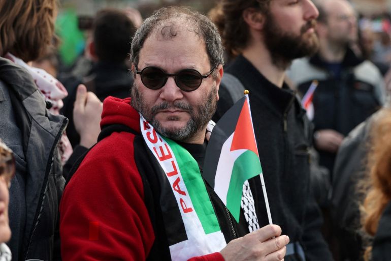 Israeli Knesset member Ofer Cassif hols a Palestinian flag as he joins Israeli left-wing peace activists and Palestinians in a demonstration against the eviction of Palestinians from their homes in the Israeli-annexed east Jerusalem neighbourhood of Sheikh Jarrah