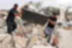 Men salvage scrap from the rubble of destroyed buildings of the Abu Wadi Bedouin community that were demolished for lack of construction permits, in the village of al-Dhahiyah near Rahat in Israel's southern district on October 12, 2026. (AFP)