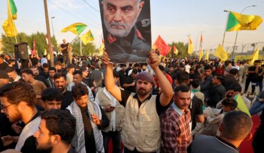 One of supporters of Iran-aligned armed factions holds up a portrait of Qassem Soleimani during a rally celebrating the withdrawal of forces of the US-led coalition against the Islamic State from Iraq, in Baghdad on September 30, 2026.