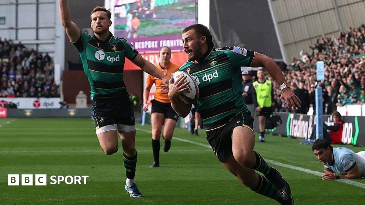 Ollie Sleightholme runs over the try line with the ball tucked under his right arm to his body as a team-mate runs in celebration behind