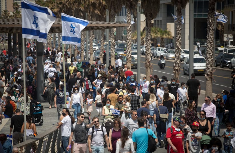 Thousands of Israelis walk on the beach boardwalk in Tel Aviv on Israel's 73d Independence Day, April 15, 2021.