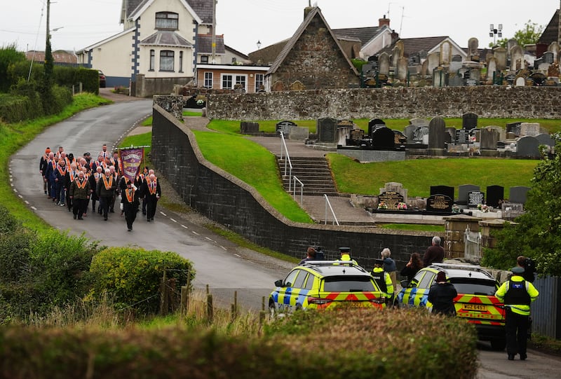Orangemen make their way from Drumcree Church as police form a barricade to prevent them entering the Garvaghy Road
