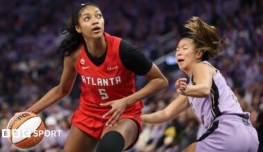 Angel Reese in a red Atlanta Dream kit, dribbles past Kaitlyn Chen in a mauve Golden State Valkyries kit