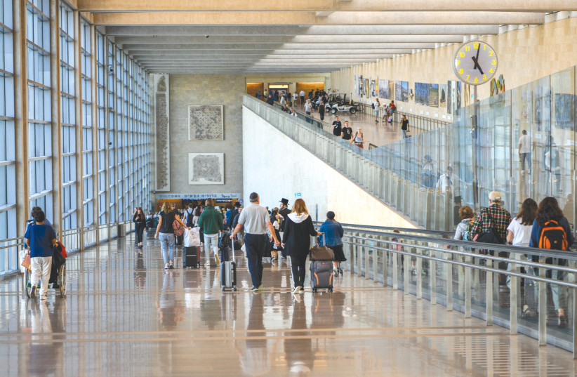 TRAVELERS COME and go at Ben-Gurion Airport