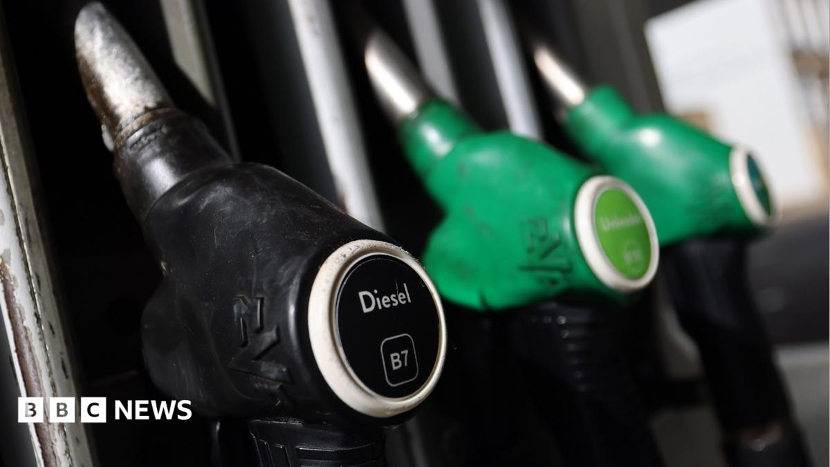 A close-up image of a black diesel pump and two green petrol pumps.