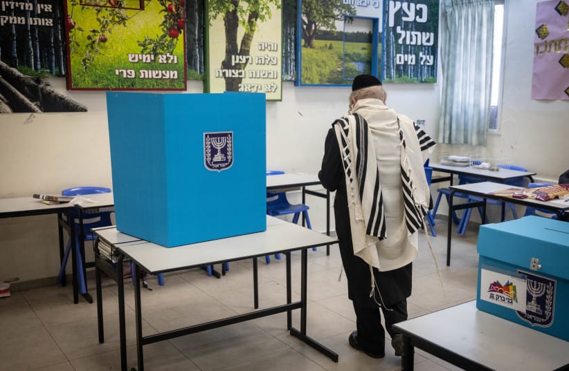 An ultra-orthodox Jewish man casts his ballot at a voting station, in Bnei Brak, on February 27, 2024.