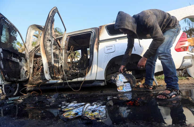 A Palestinian inspects near a vehicle where employees from the World Central Kitchen (WCK), including foreigners, were killed in an Israeli airstrike. April 2, 2024.