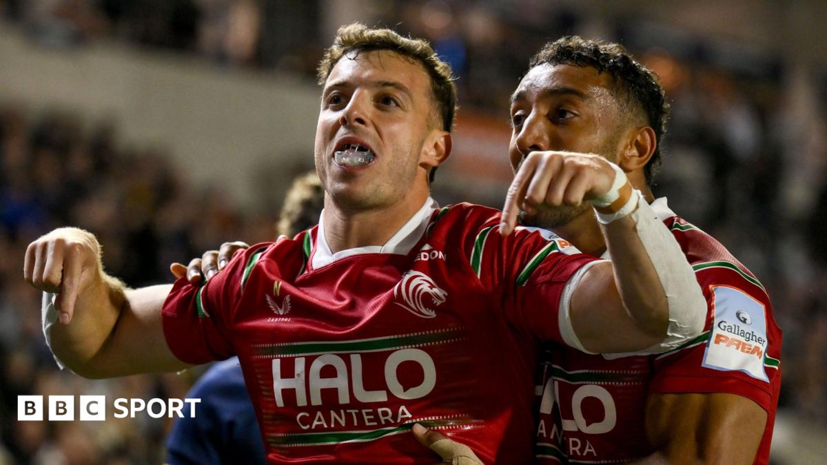 Leicester Tigers' Adam Radwan celebrates scoring a try by holding his hands out with his index fingers downwards