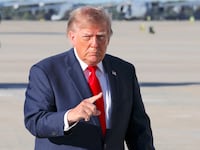 US President Donald Trump gestures as he walks to board Air Force One to travel to South Carolina for a Republican rally ahead of the midterm elections, at Joint Base Andrews, Maryland, US October 21, 2026.