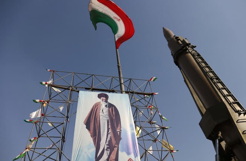  An Iranian missile system is displayed next to a banner with a picture of Iran's Supreme Leader Ayatollah Ali Khamenei, during Iranian defence week, in a street in Tehran, Iran, September 24, 2024.