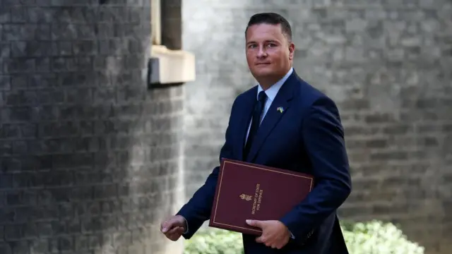 Wes Streeting arriving at Downing Street carrying a dark red folder which reads Secretary of state for defence