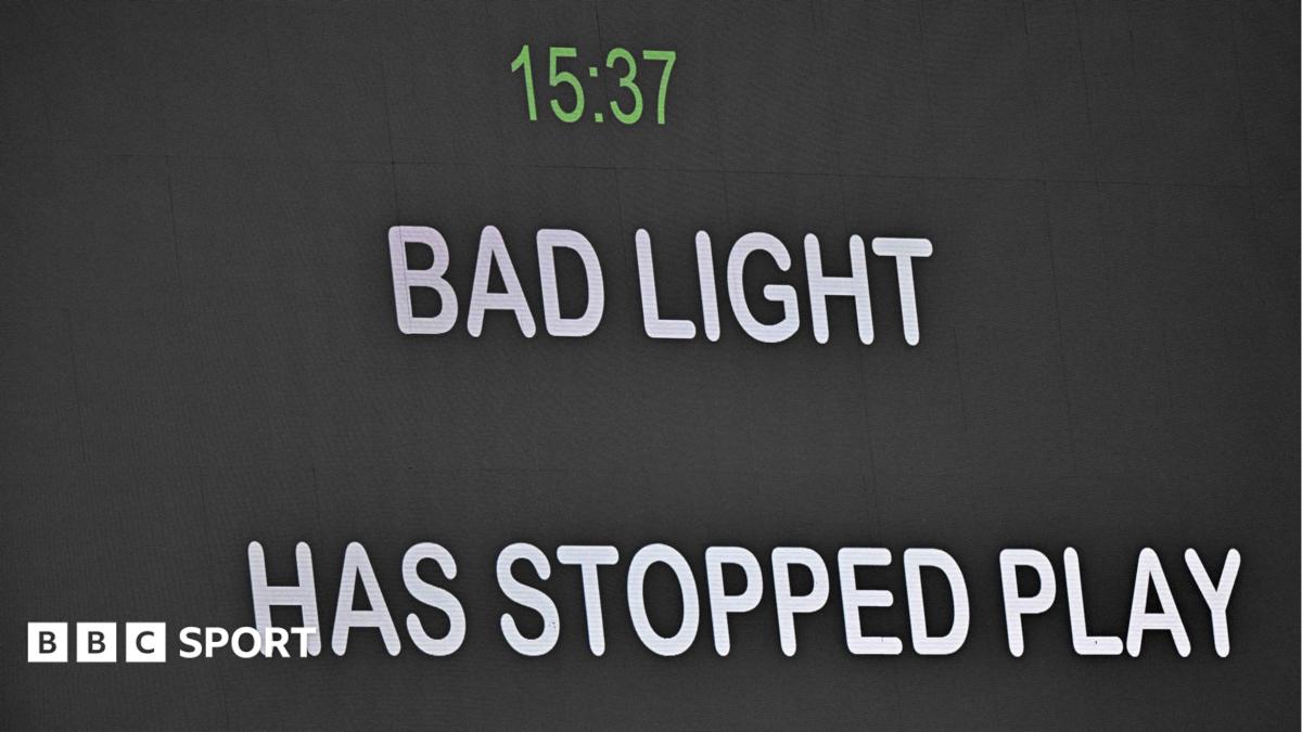 Message telling spectators bad light has stopped play is shown on the big screen