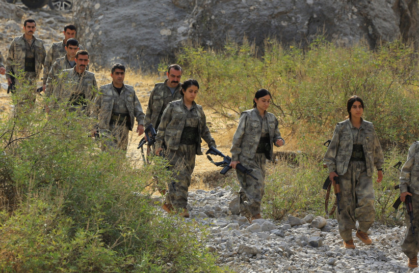 Fighters with the Kurdistan Workers' Party (PKK) walk for a disarmament ceremony marking a significant step toward ending the decades-long conflict between Turkey and the outlawed group, in the Qandil mountains, Iraq October 26, 2025.