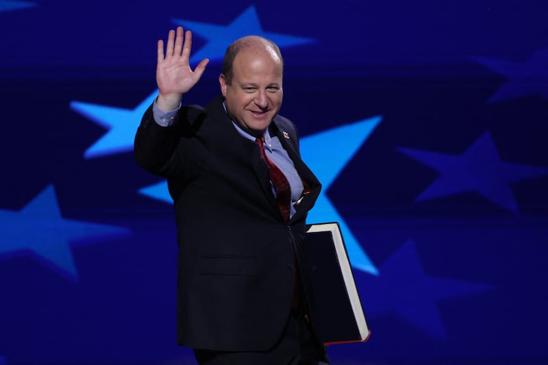 Colorado Governor Jared Polis holds a "Project 2025" book on Day 3 of the Democratic National Convention (DNC) in Chicago, Illinois, U.S., August 21, 2024. REUTERS/Mike Segar
