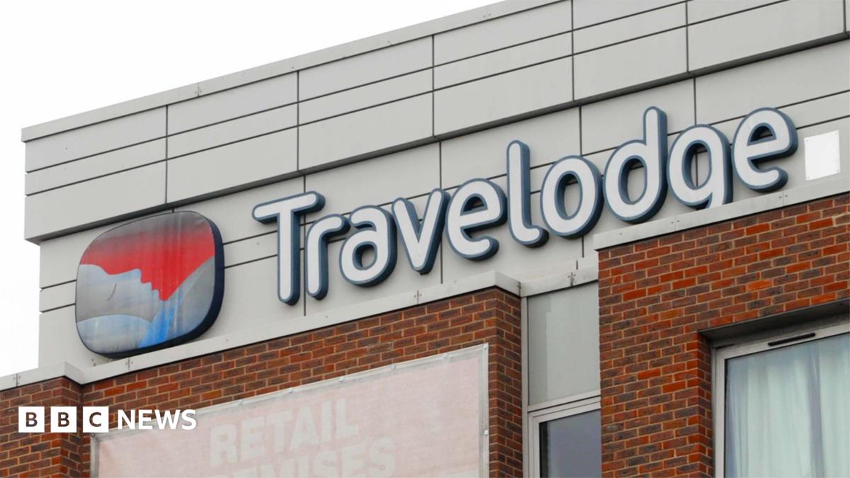 A shot of the Travelodge logo on one of a hotel building.