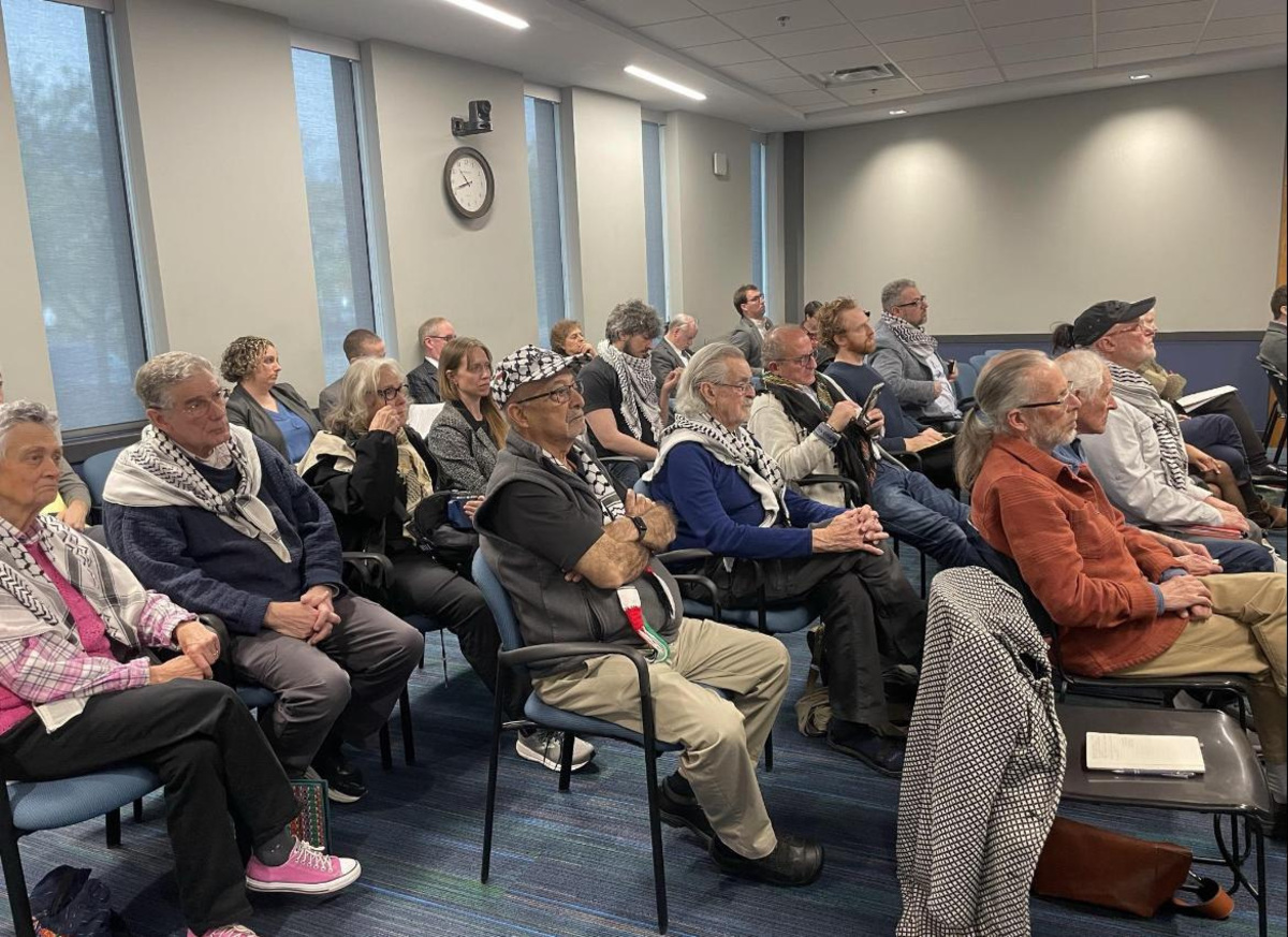 Individuals opposed to state funding for the Michigan Israel Business Accelerator (MIBA) wait to speak during public comment at the May 12, 2026 Michigan Economic Development Corporation executive committee meeting in Lansing.