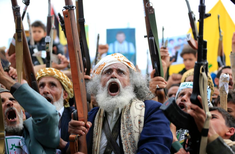 Supporters of the Iran-backed Houthi movement brandish their weapons as they rally in solidarity with Iran and Lebanon amid the Middle East war, in the capital Sanaa on April 17, 2026.