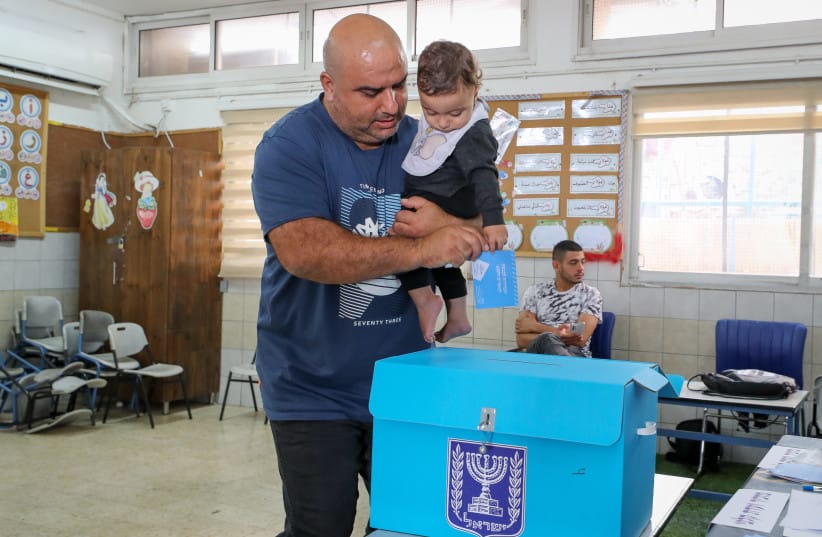 AN ARAB ISRAELI citizen casts his vote at a polling station in Mughar in the 2022 election.